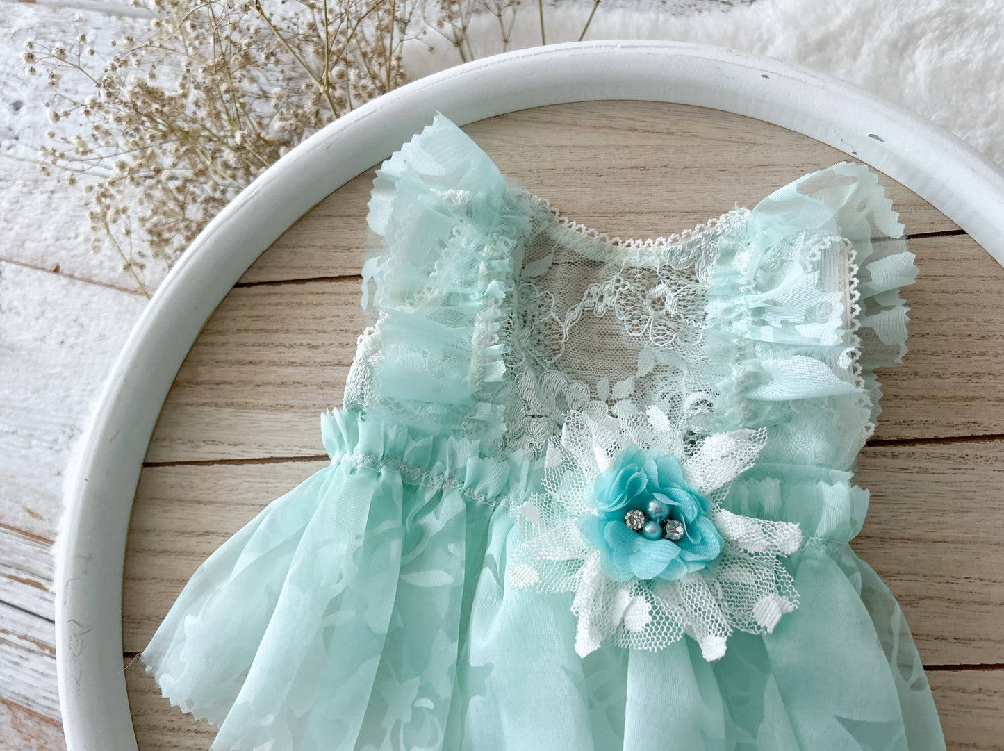 Mint green dress with lace details and a flower accessory for photography shoots