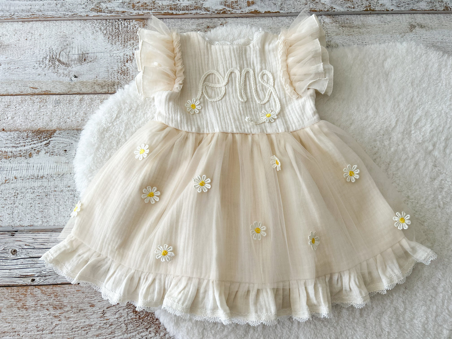 Light yellow sitter dress for photography sessions, with one embroidered on top and daisy flowers on tulle skirt