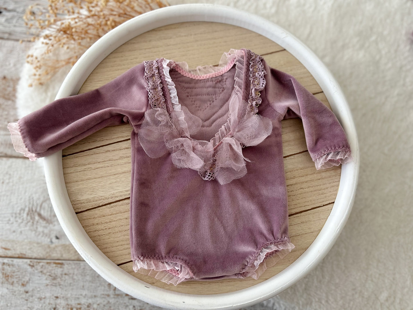 Velvet newborn romper in mauve with lace V-neck –back view