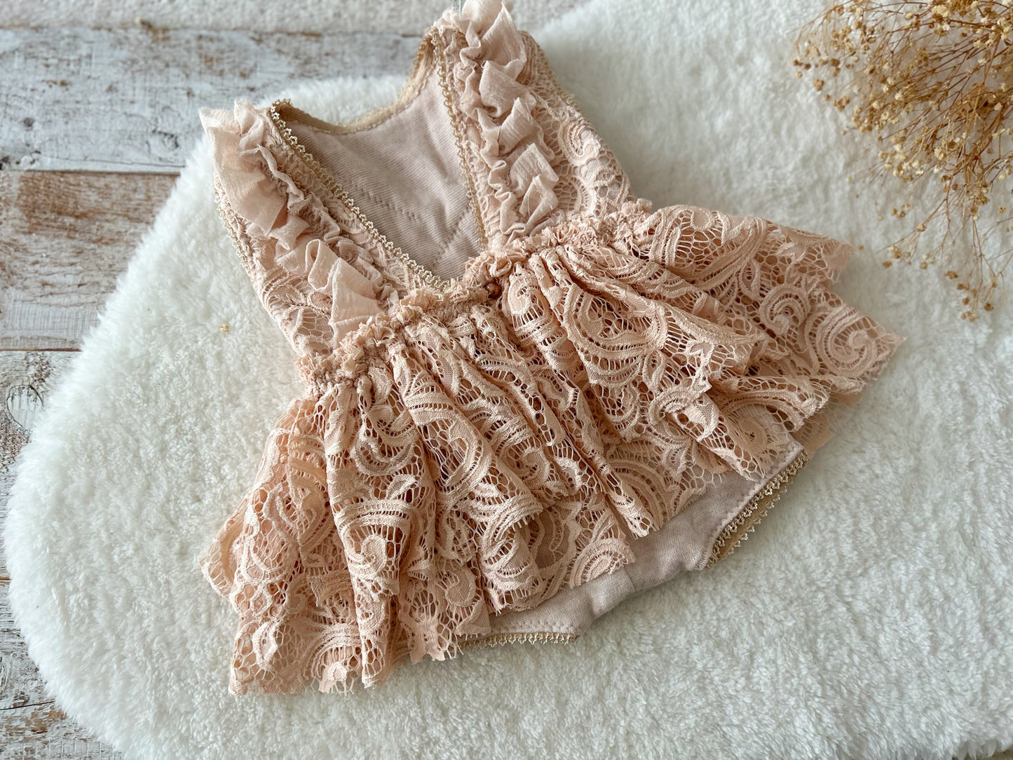 Back view of vintage-style baby girl romper with double-layer lace skirt and soft ruffles