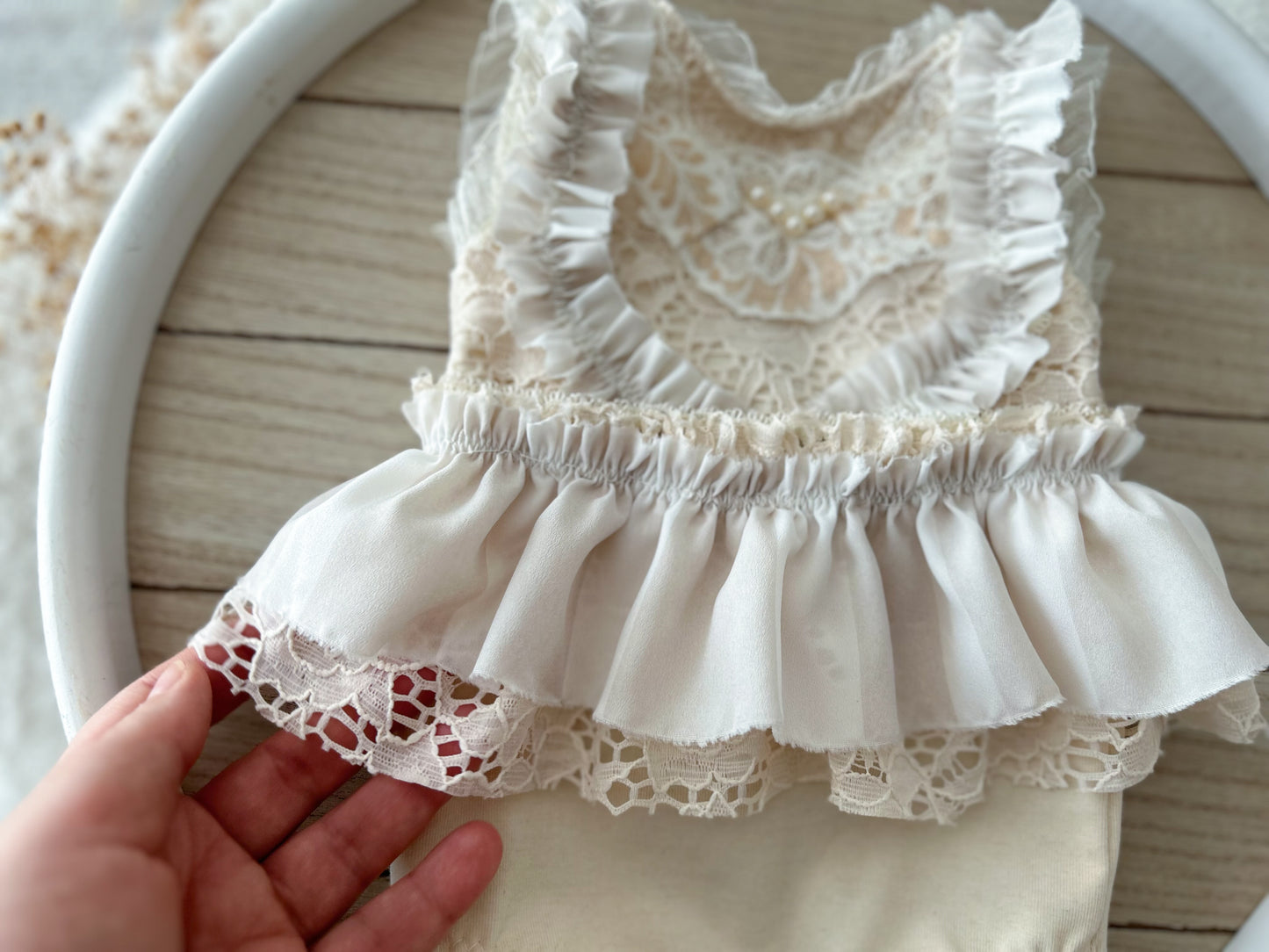 Detailed view of lace ruffled skirt of newborn photo outfit