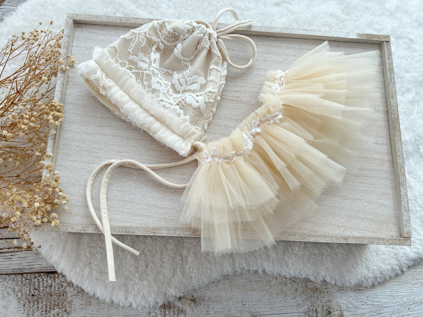 Newborn girl outfit: bonnet and ruffled tulle tutu skirt in warm beige