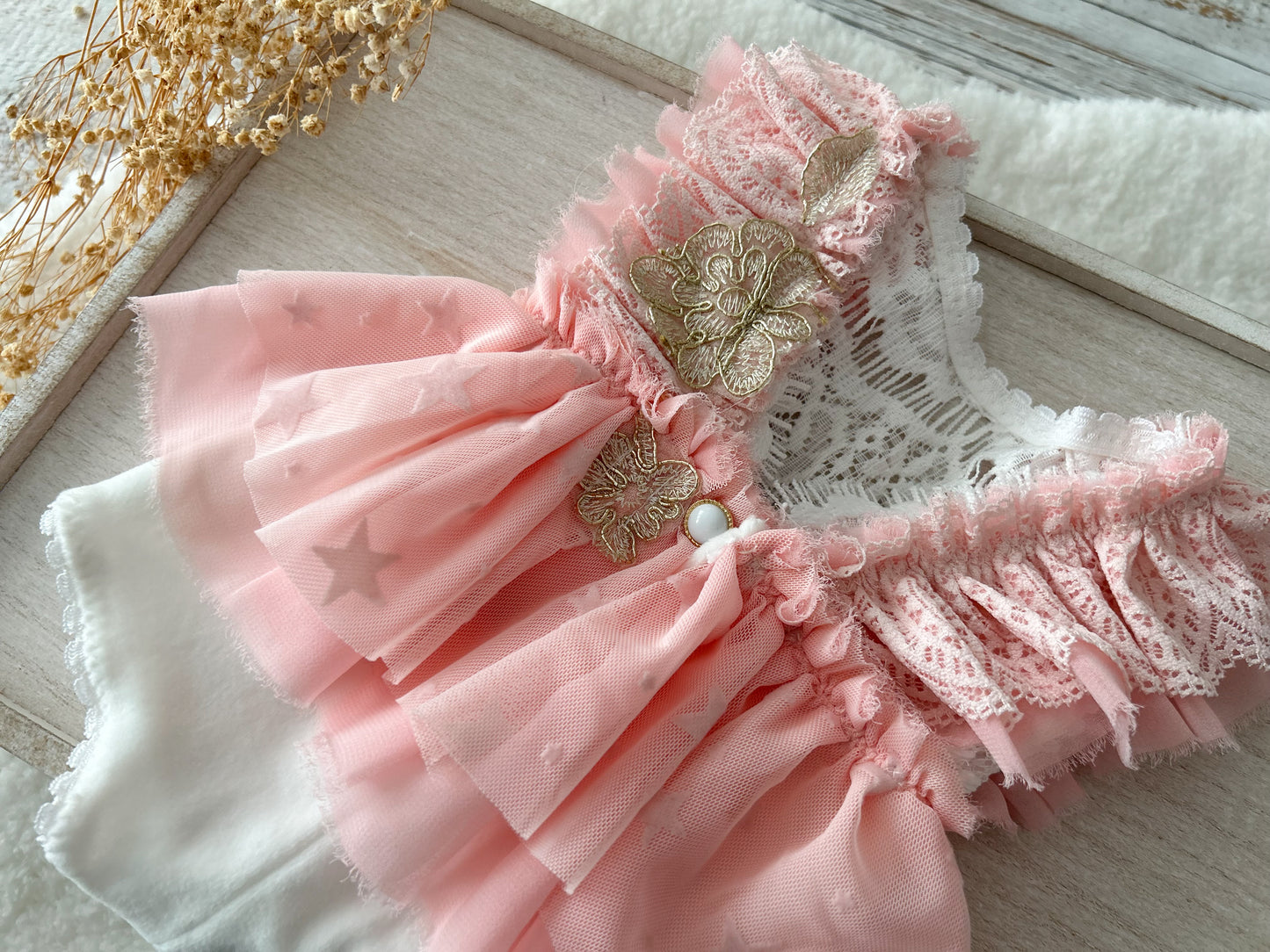 A detailed shot highlighting the ruffled lace sleeves and the gathered waistline with flowing chiffon layers.