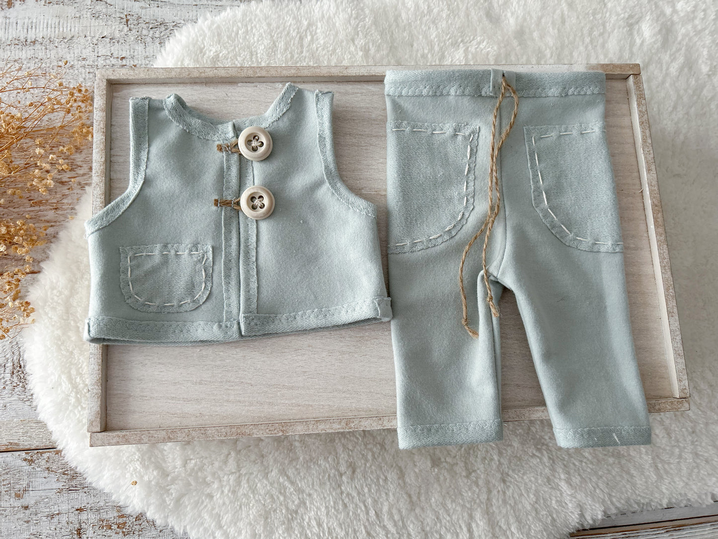 Close-up of vest and pants with hand-stitched details in duck egg blue newborn set