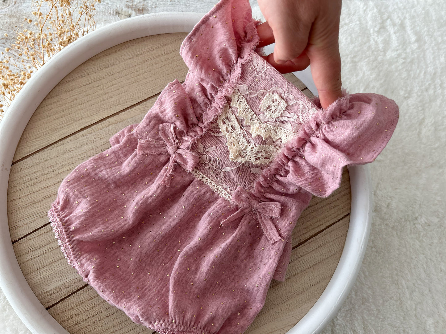 Pink newborn romper with ruffles in boho style