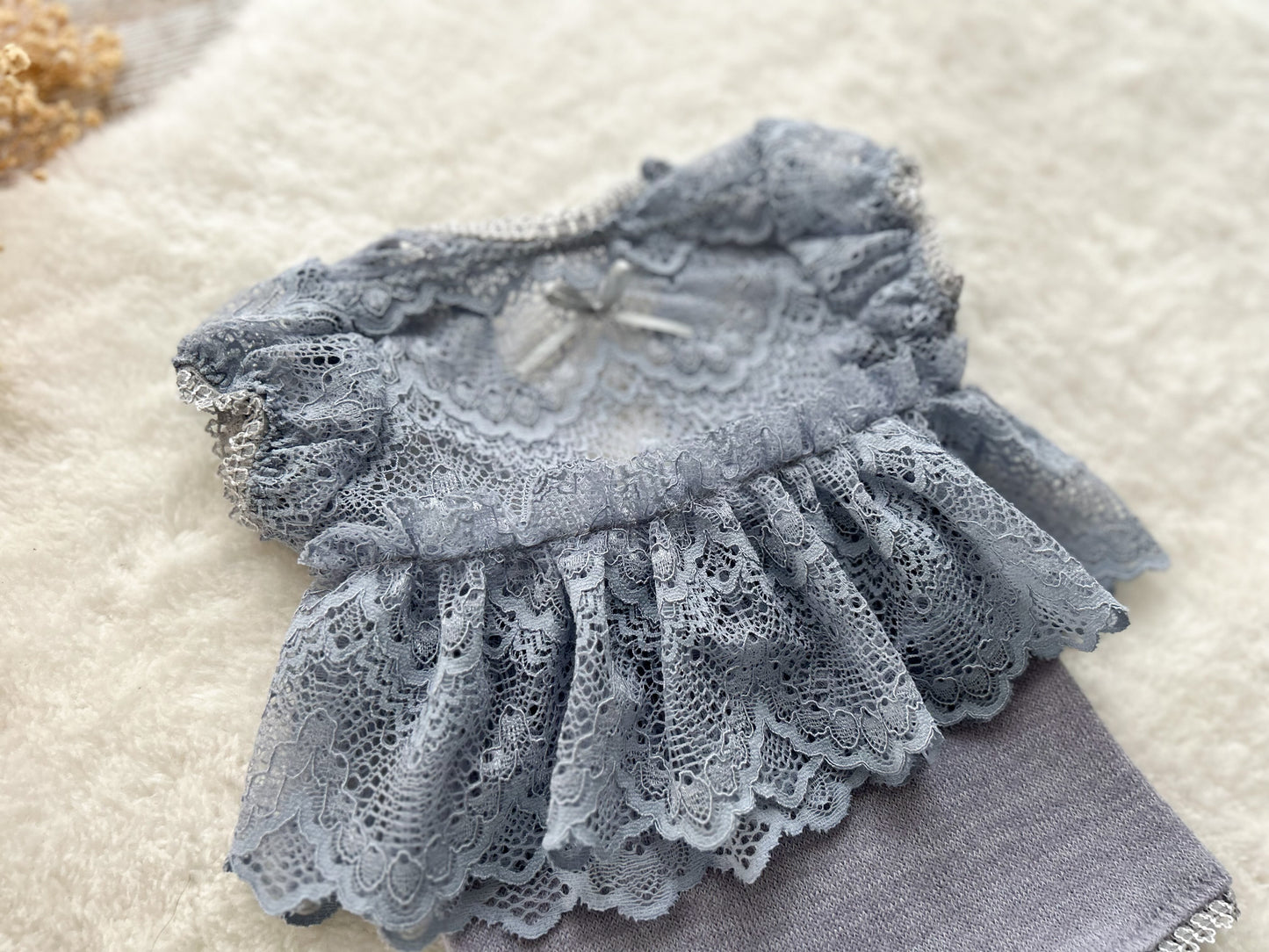 Close-up on a lace baby girl romper for newborn photography