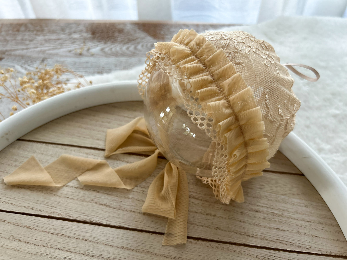 Beige newborn lace bonnet with floral texture and ruffles for newborn photography