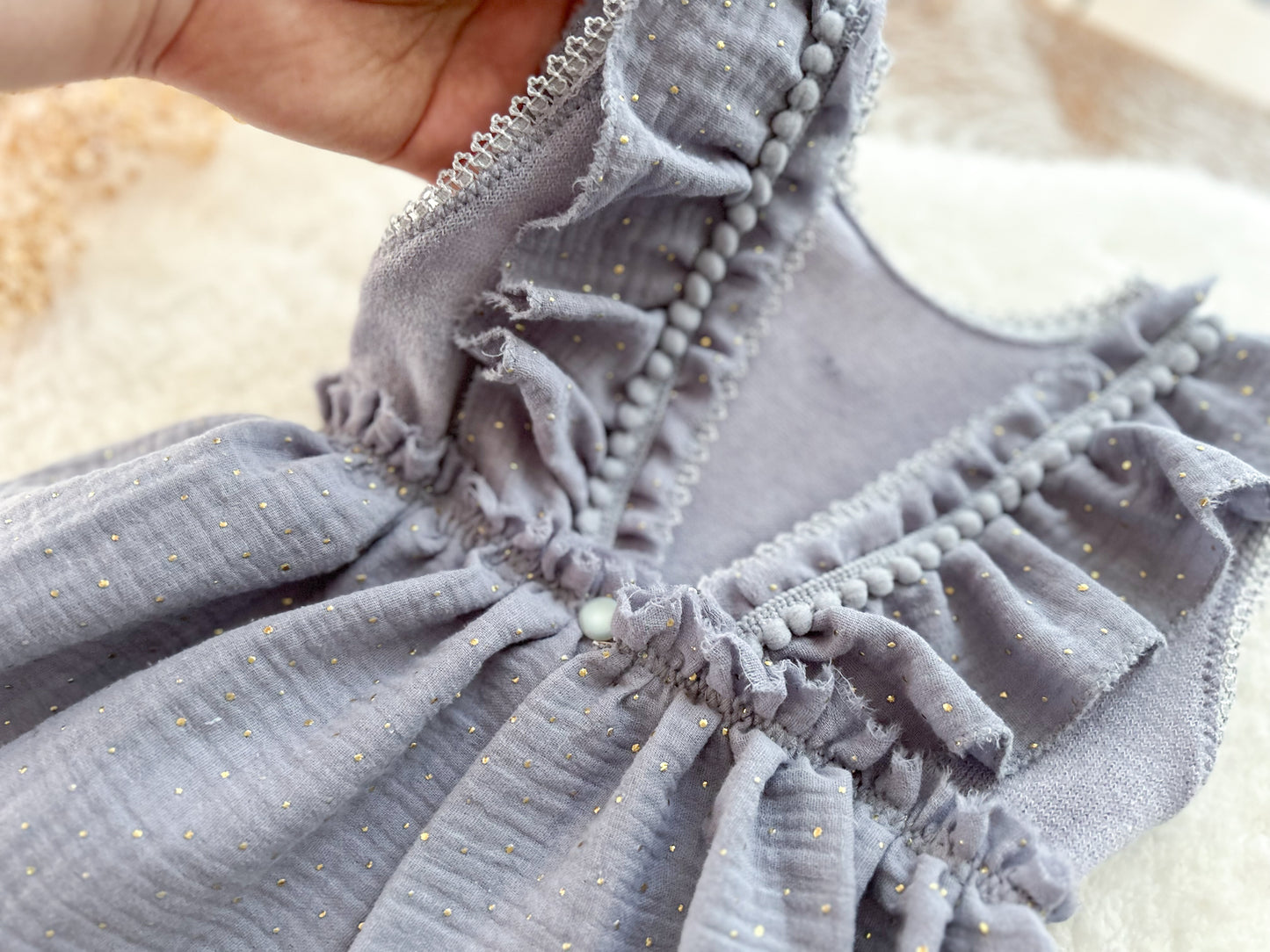 Close-up of a gray textured fabric with ruffled edges on a beige background