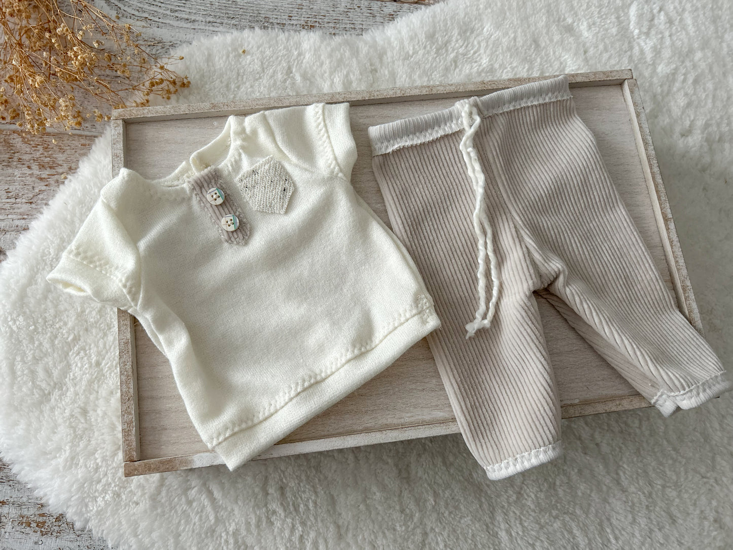 Detail of soft corduroy texture and cream top with rustic style baby buttons