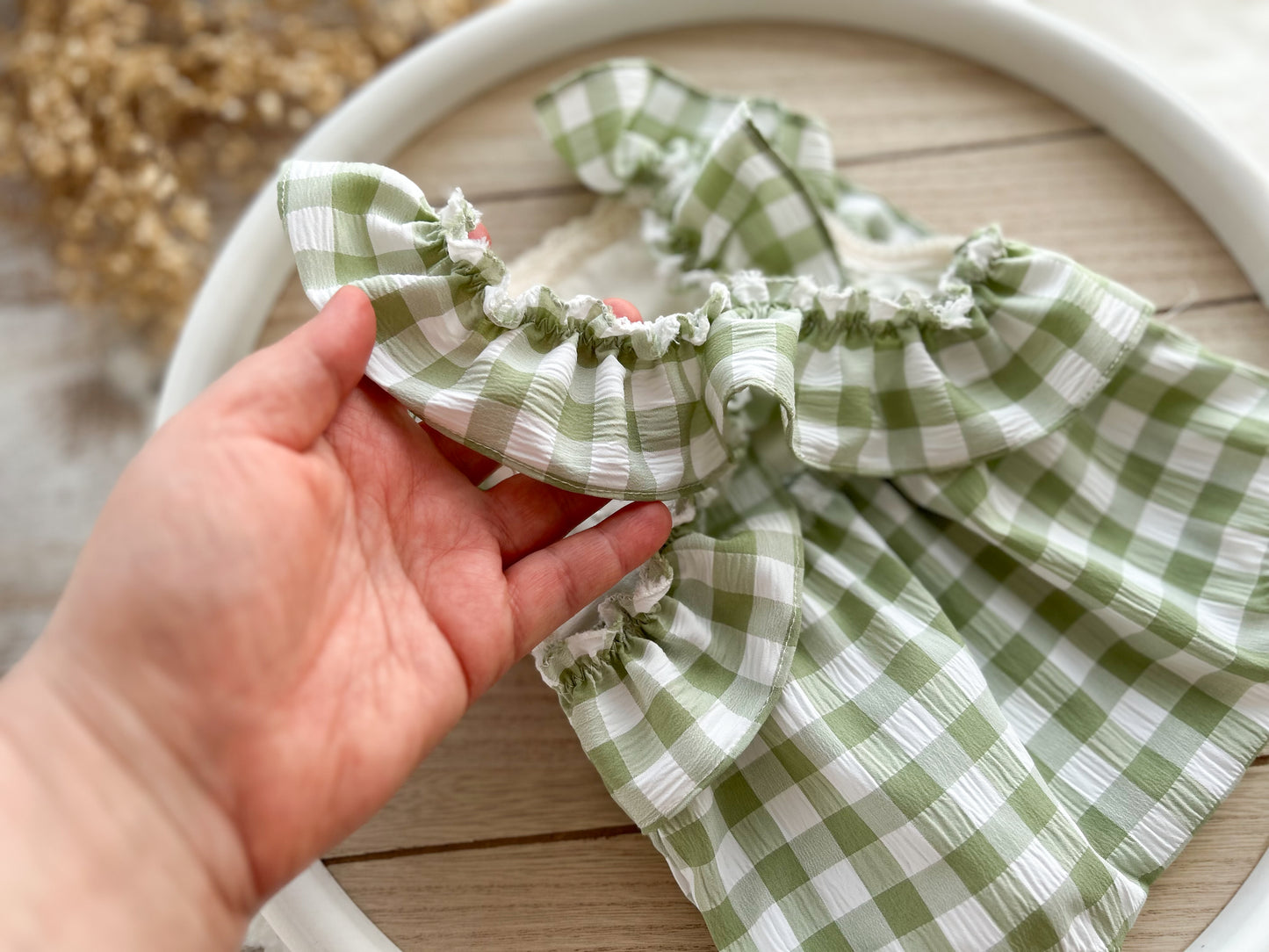 The back of the green and ivory romper with ruffles on the back, perfect as newborn photography prop