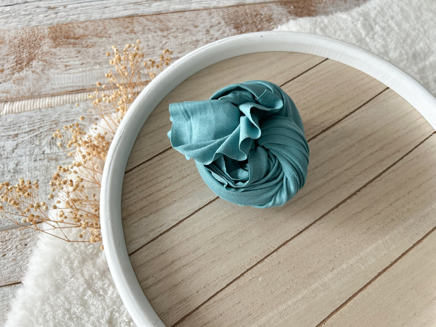 Dusty teal newborn photo wrap with soft cotton stretch.