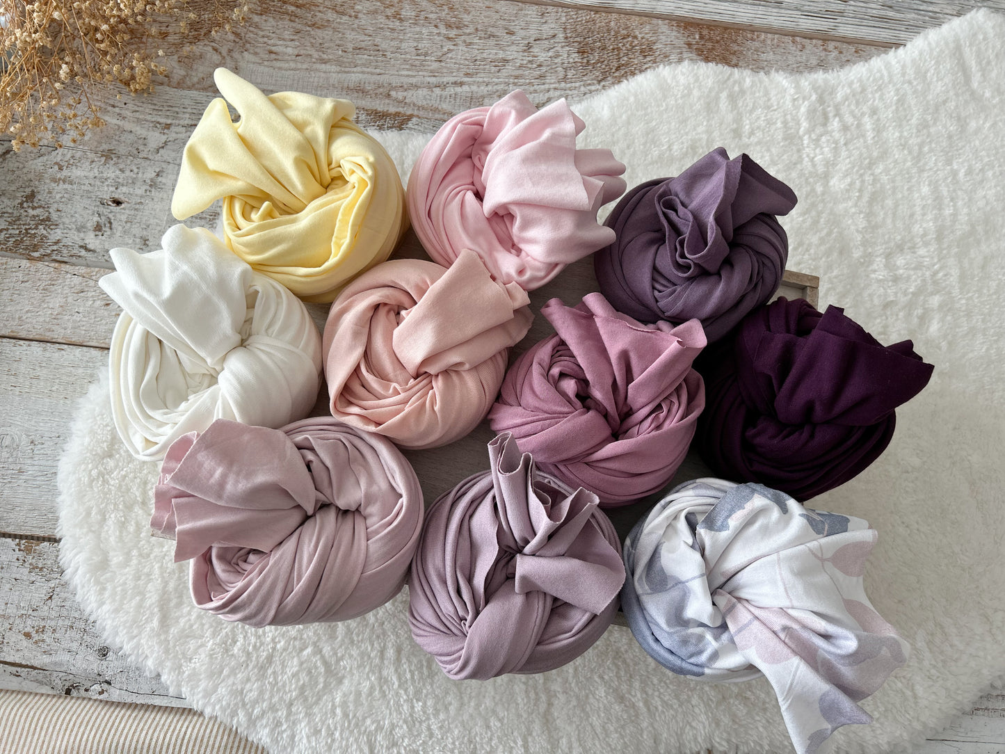 A selection of 10 colors of newborn wraps for newborn photography from pastels to rich dark colors