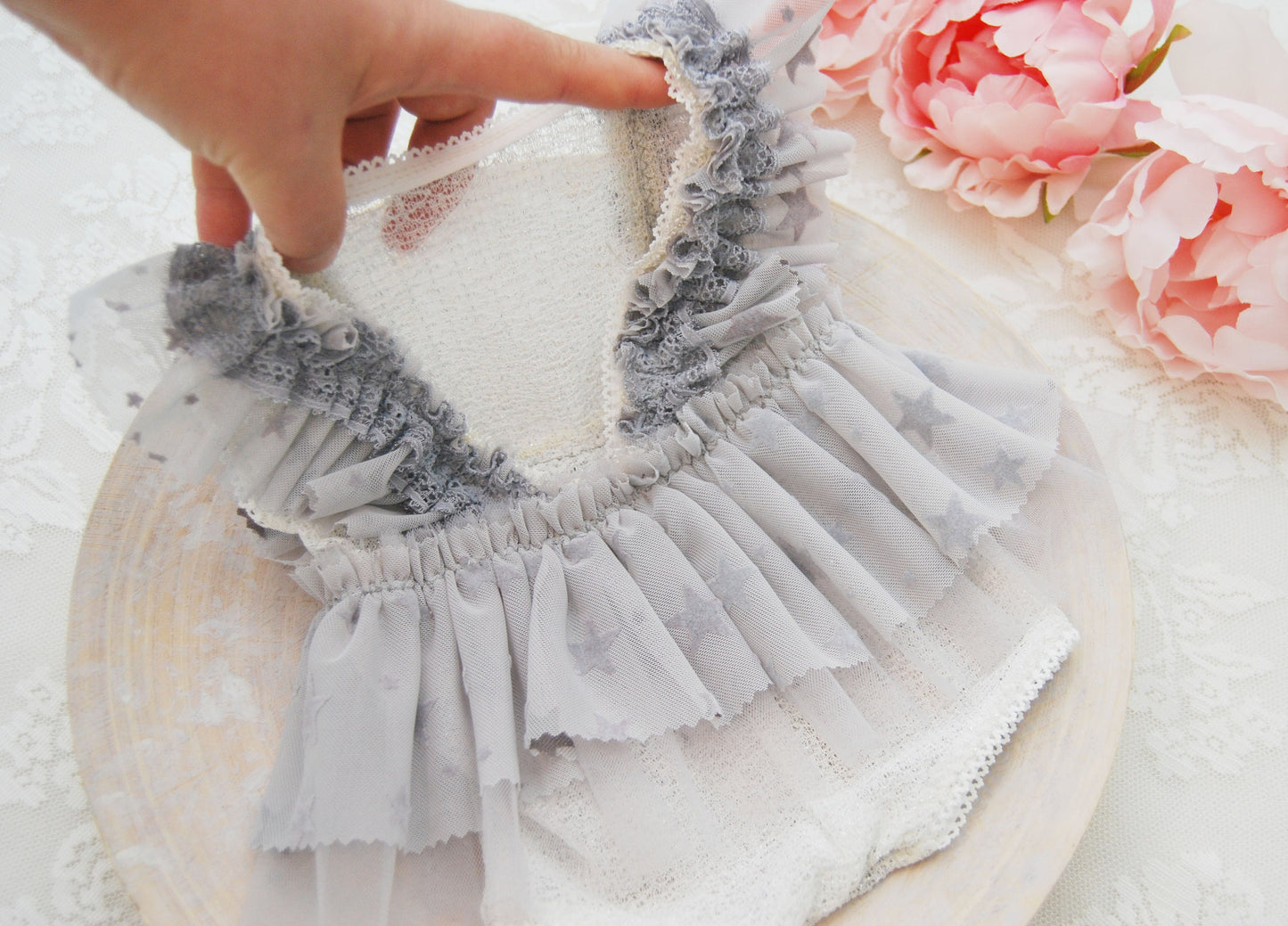 Close-up on the back of the romper that features a V shape for comfort and easy dressing on the baby.