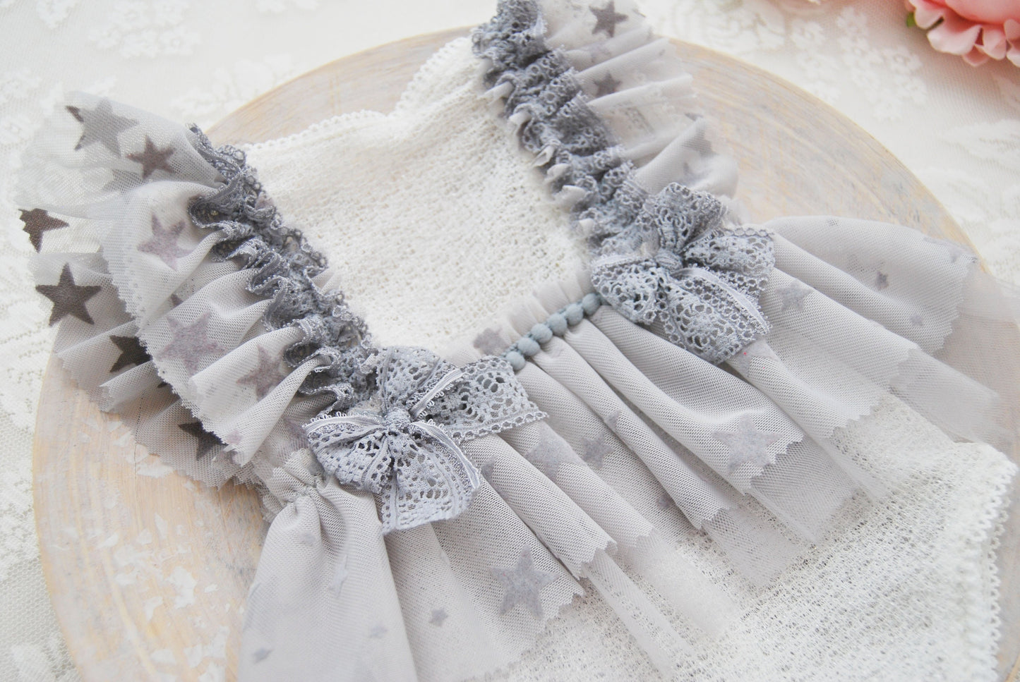 Close-up on the front of the baby romper with celestial pattern.
