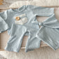 Newborn photography outfit with knit texture and pastel tones, perfect for boys.