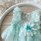 Mint green dress with lace details and a flower accessory for photography shoots