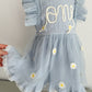 Light blue dress with floral embroidery on a mannequin against a neutral background