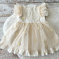 Light yellow sitter dress for photography sessions, with one embroidered on top and daisy flowers on tulle skirt