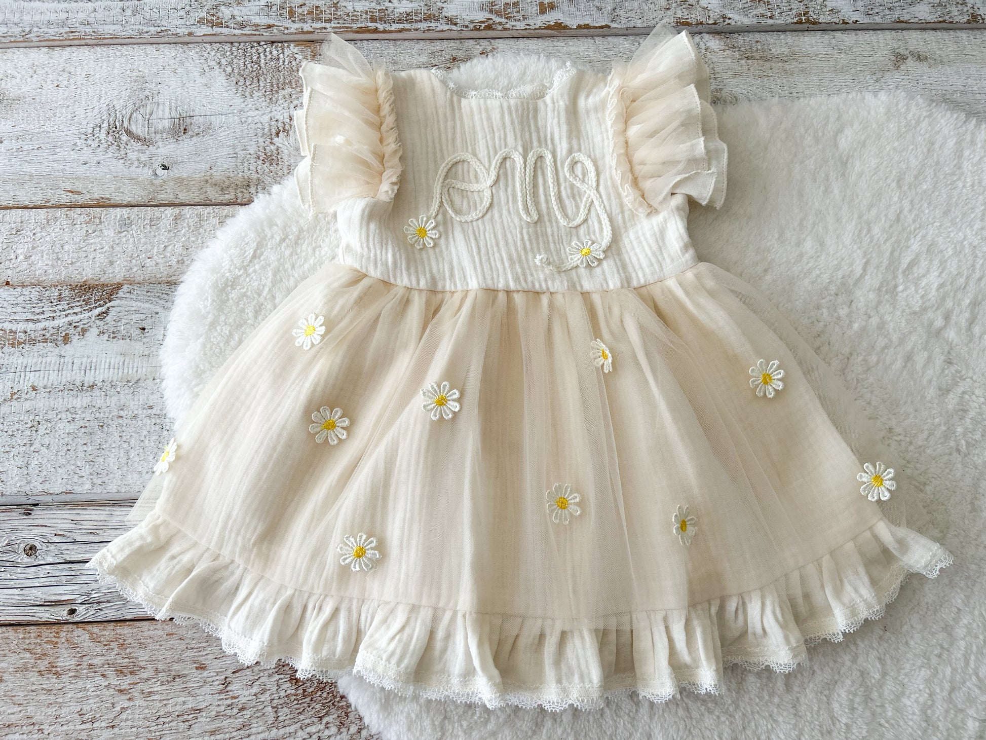 Light yellow sitter dress for photography sessions, with one embroidered on top and daisy flowers on tulle skirt