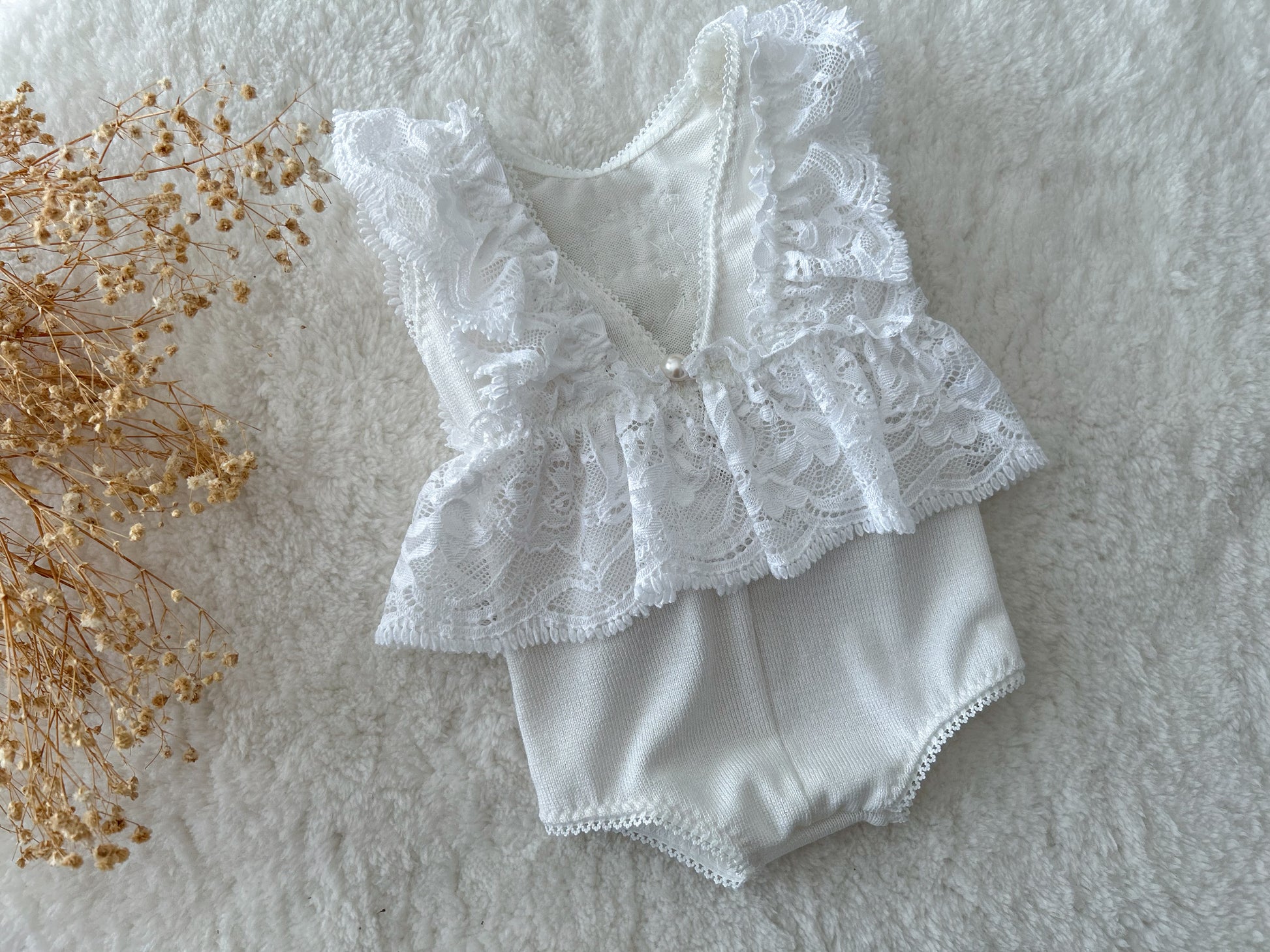 All white ruffled romper for newborn photo shoots