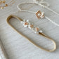 Set of two newborn photo prop headbands: one stretchy floral headband and one adjustable tie-back with pearl flower.