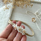 Close-up of delicate baby headband with soft band and floral appliqué, perfect for photography sessions.