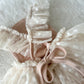 Baby girl photo prop sitter with ruffled straps criss crossed on the back