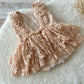 Back view of vintage-style baby girl romper with double-layer lace skirt and soft ruffles