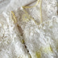 White lace newborn photo outfit with floral details on a light background
