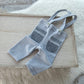 Light blue baby pants with gray accents on a wooden surface