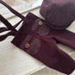 Purple baby outfit with buttons on a light wooden surface