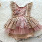 Front view of a baby girl sitter outfit with pink tulle skirt, lace bodice, and 3D flower decorations — perfect for photo shoots.