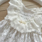 Detailed view of floral lace romper with flutter sleeves