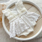 White lace fabric on a wooden surface with a white circular object