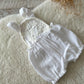 Full view of white baby photo prop romper with soft cotton texture

