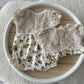 Two vintage-inspired newborn rompers with lace and yellow roses – side by side styling
