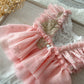 A detailed shot highlighting the ruffled lace sleeves and the gathered waistline with flowing chiffon layers.