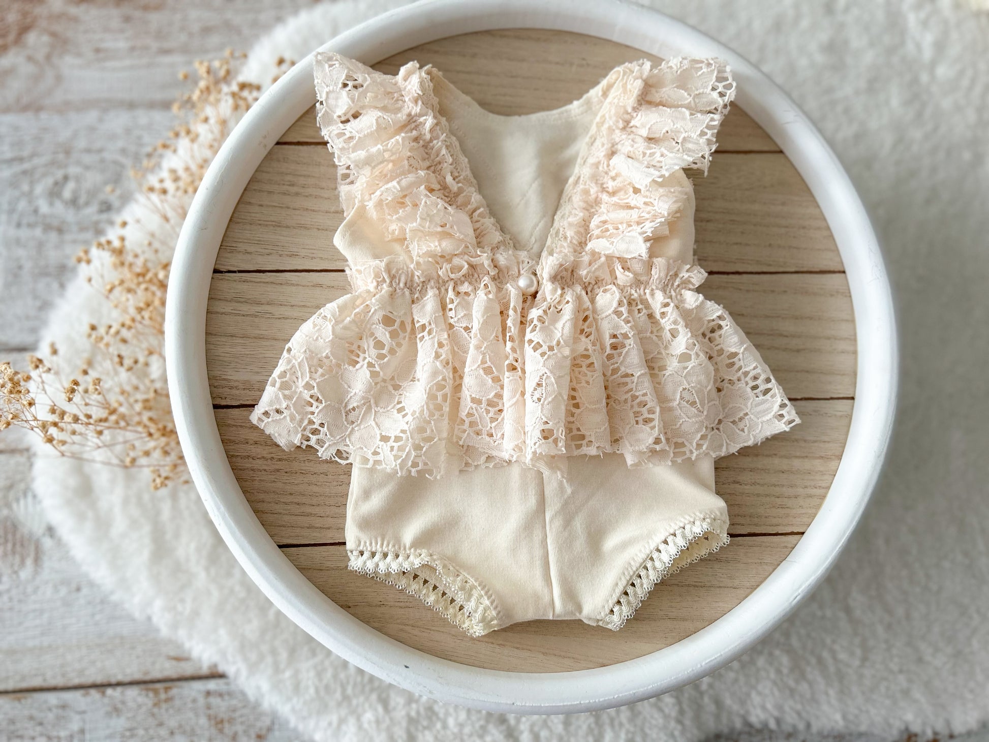 The back of the newborn photo outfit with lace ruffles, vintage boho style