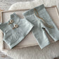 Duck egg blue newborn vest and pants on wooden tray. 