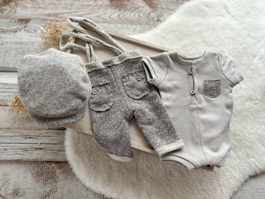 Gray newborn boy photo outfit with romper, suspenders, and flat cap for photo shoots