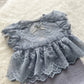 Close-up on a lace baby girl romper for newborn photography