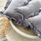 Close-up on newborn posing pillow with ruffles