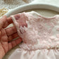 Close up on short lace sleeves of a newborn photo outfit