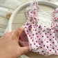 Close-up of pink polka dot romper  and the elasticated leg openings