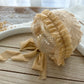 Beige newborn lace bonnet with floral texture and ruffles for newborn photography