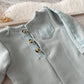 Duck egg blue newborn romper with matching sleepy hat on soft cream background

