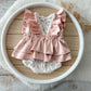 Baby girl outfit with satin shoulder ruffles and layered ruffle back

