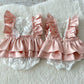 newborn photo outfit with ruffles in blush pink color and white lace 

