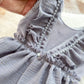 Close-up of a gray textured fabric with ruffled edges on a beige background
