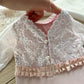 Newborn photography romper for baby girls first photo shoot made of soft jersey fabric and lace in light pink color, with ruffles